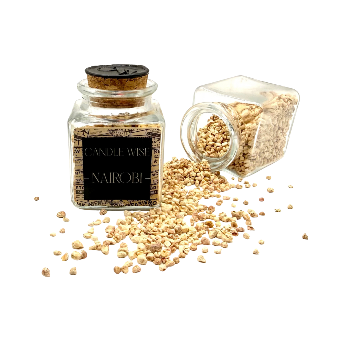 CANDLE WISE Nairobi drawer diffuser glass jar standing beside an open tilted jar with scented corn cob granules spilling onto a clean background.