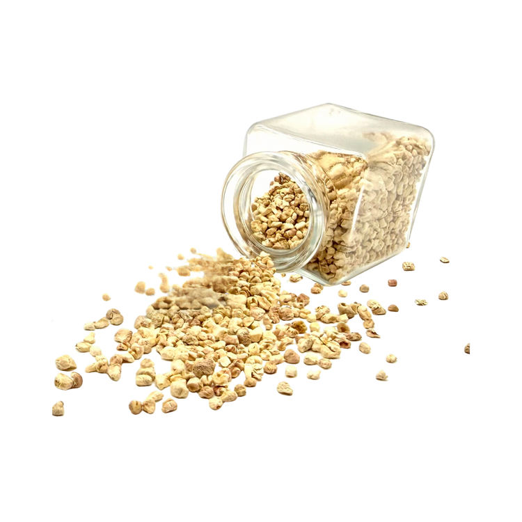 Open glass jar drawer diffuser with scented corn cob granules spilling onto a white background.
