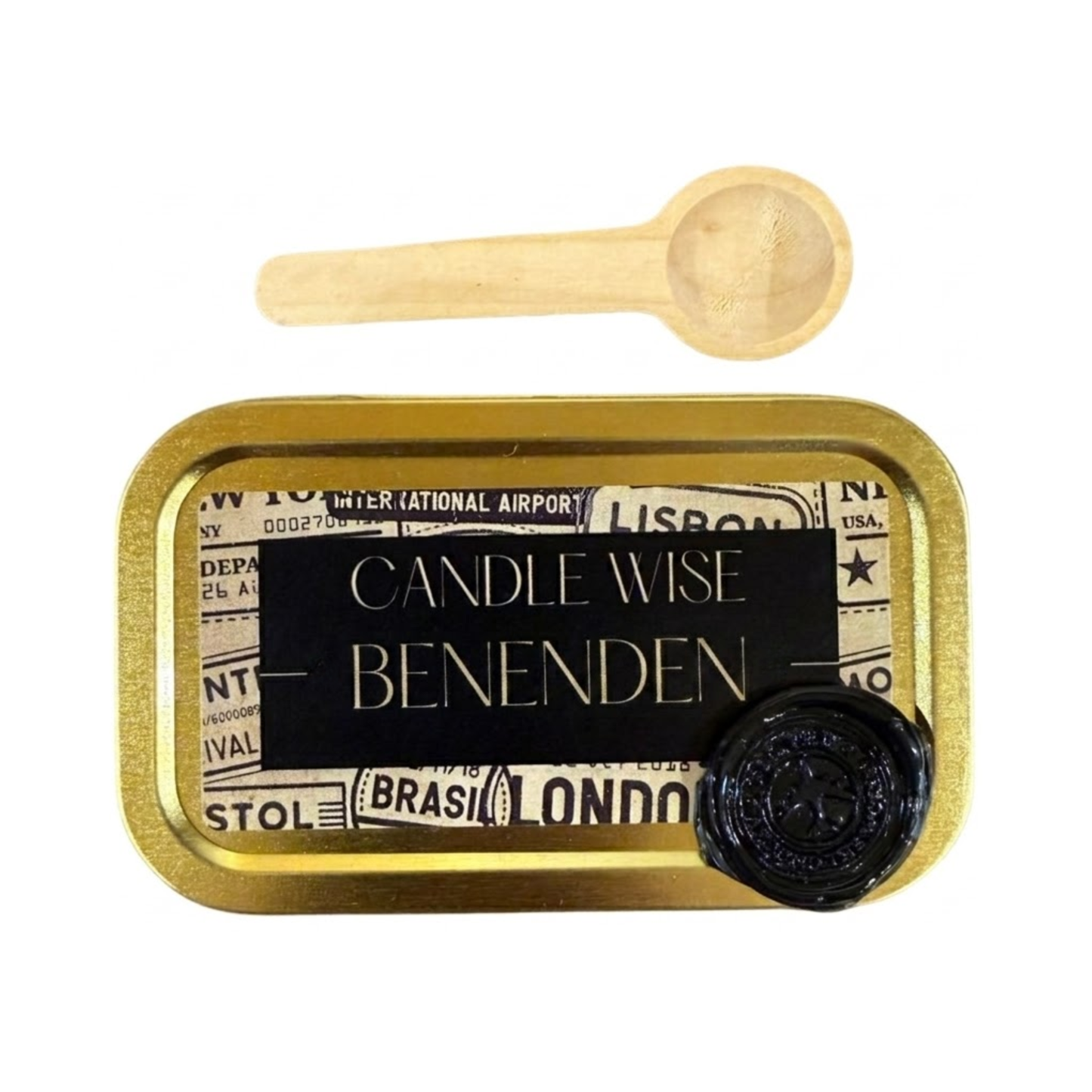 A top down view of a gold rectangular tin with a black and vintage travel themed label. The label features the text Candle Wise BENENDEN in capital letters and a black wax seal. A small wooden scoop is placed above the tin.
