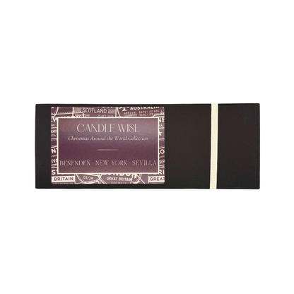 Candle Wise Christmas Around the World Trio Candle Gift Set in a closed black presentation box with ribbon detail