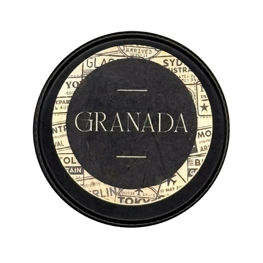 Candle Wise Granada solid perfume closed black tin lid featuring vintage passport stamp label design.