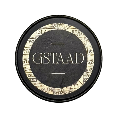 Candle Wise Gstaad solid perfume closed black tin lid featuring vintage travel label.