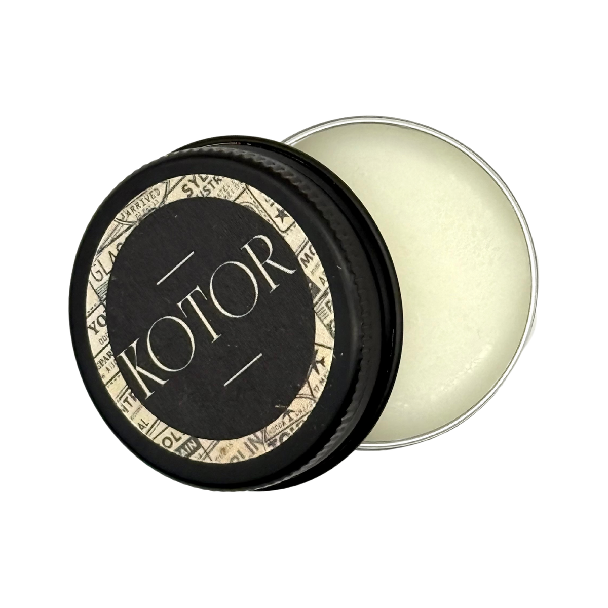 Candle Wise Kotor solid perfume open black tin showing white balm and lid.