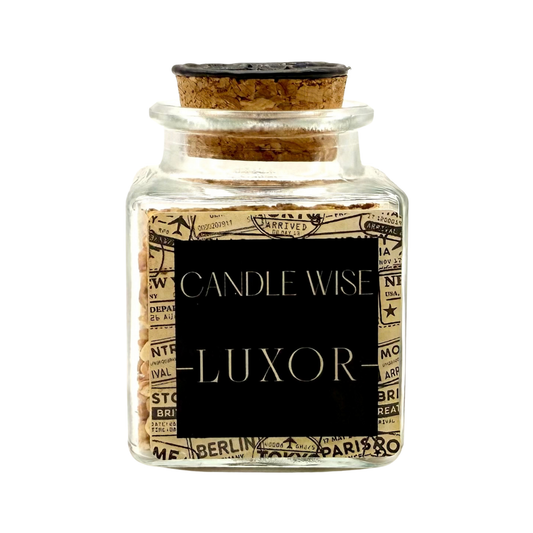 CANDLE WISE Luxor scented corn cob granule drawer diffuser in a square glass jar with a cork stopper and black wax seal, front view.