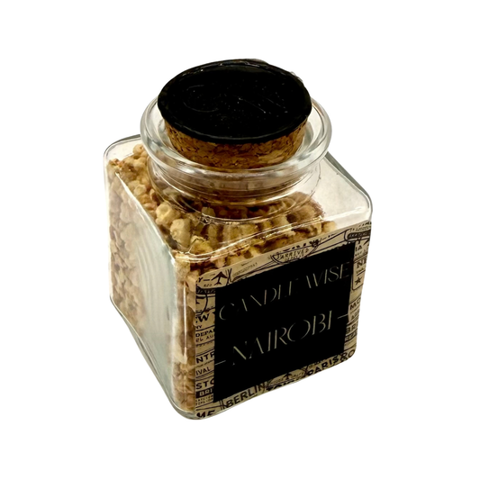 Angled top view of CANDLE WISE Nairobi open jar drawer diffuser showing the natural cork stopper with stamped wax seal and filled corn cob granules.