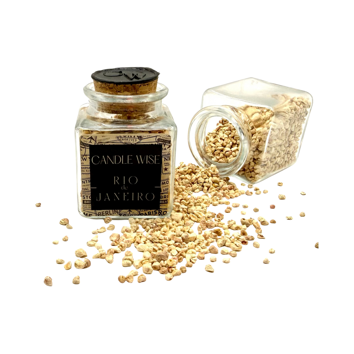 CANDLE WISE Rio drawer diffuser glass jar standing beside an open tilted jar with scented corn cob granules spilling onto a clean background.