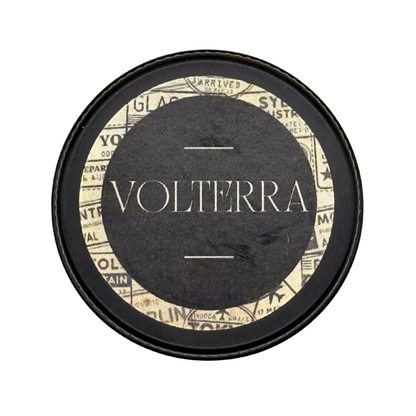 Candle Wise Volterra solid perfume closed black tin lid with vintage travel label.