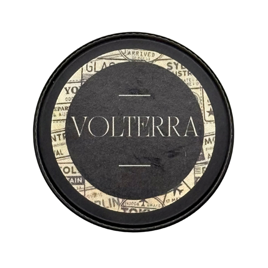 Candle Wise Volterra solid perfume closed black tin lid with vintage travel label.