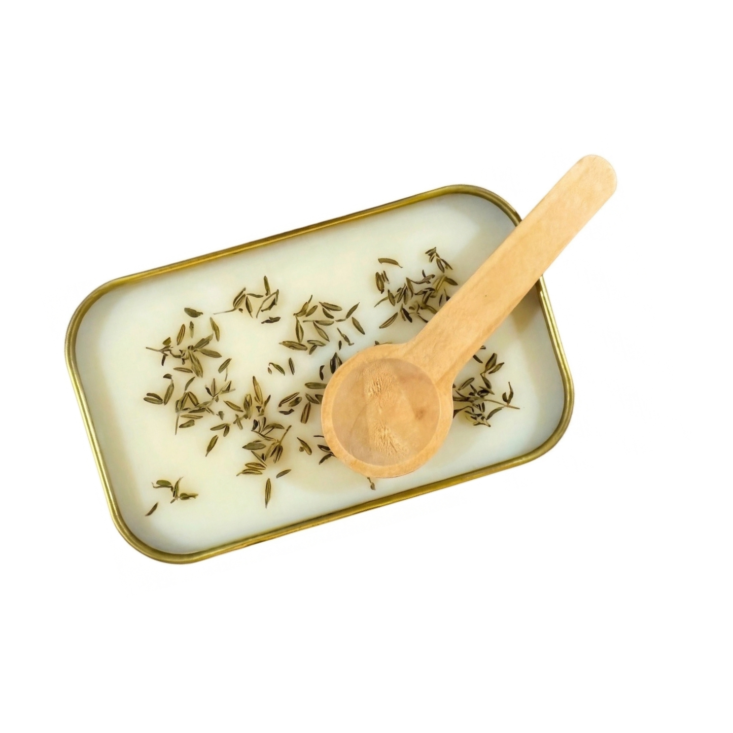 Close up of white scoopable wax in a gold tin topped with dried thyme and a wooden measuring spoon.